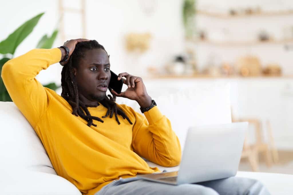 internet scam shocked black man looking at laptop 2022 12 16 07 01 18 utc