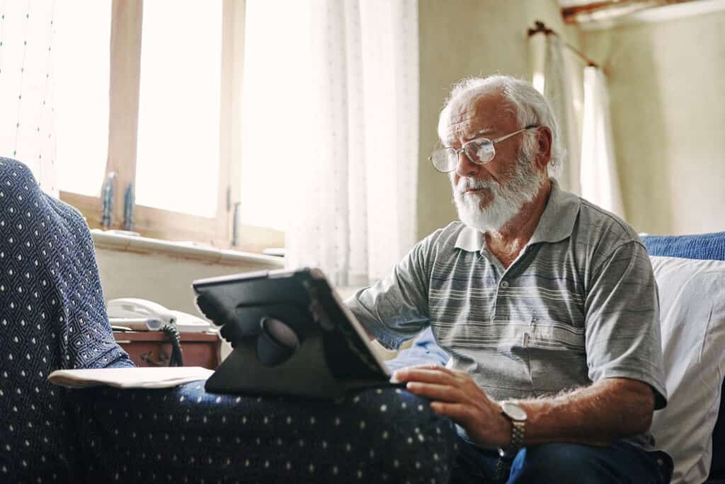 Mature man using a tablet for online banking