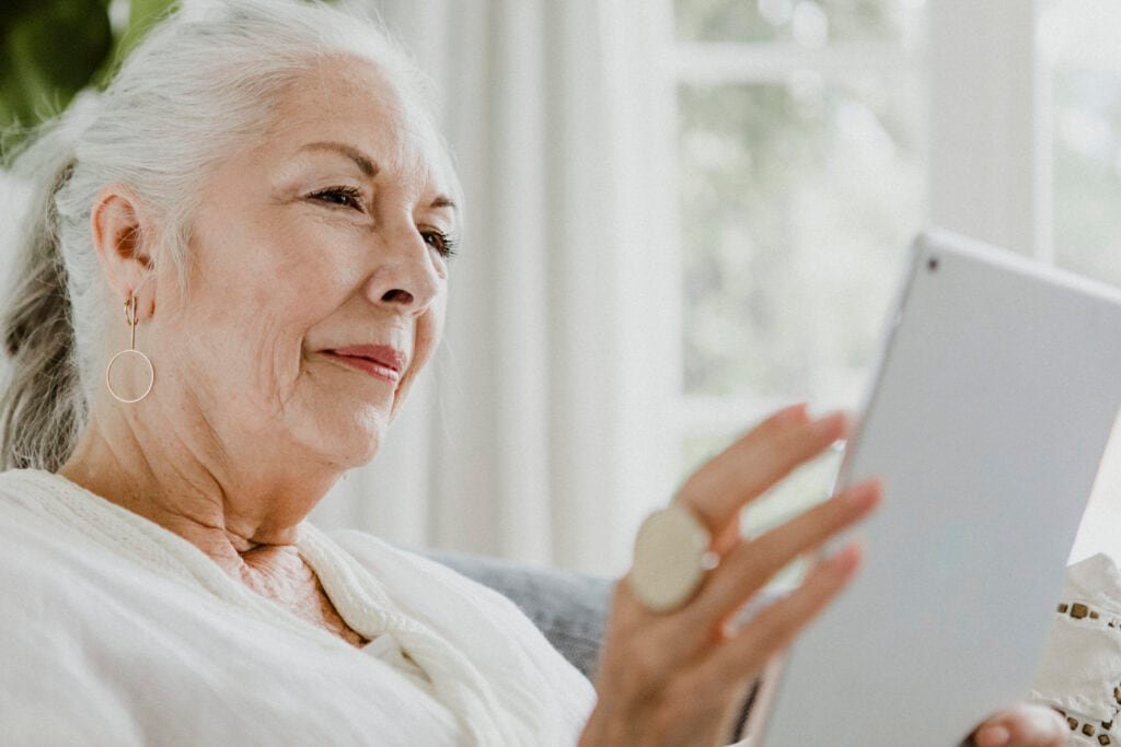 Mature woman using a tablet wondering is online banking safe