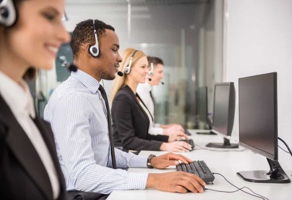 Line of phone operators with headsets asking calls and helping victims of fraud such as those affected by the Quantum AI Scam