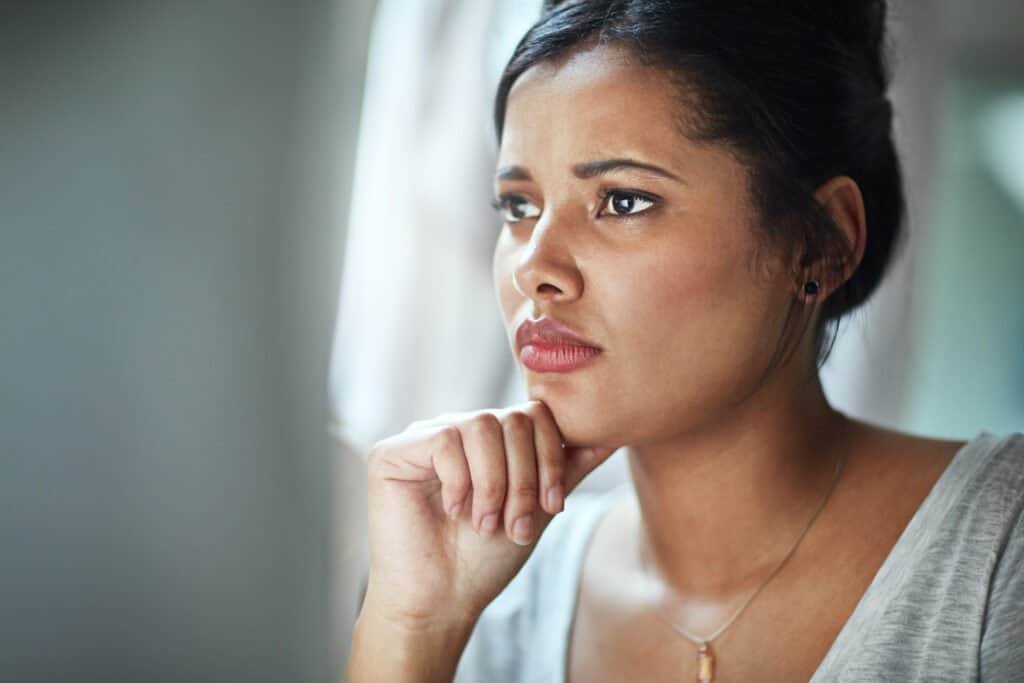 A woman contemplating how she will handle being a victim of an Amazon scam email