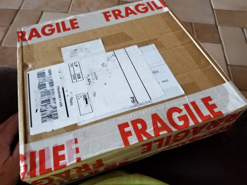 Box with fragile tape on it left in a safe area as no one at home when delivered