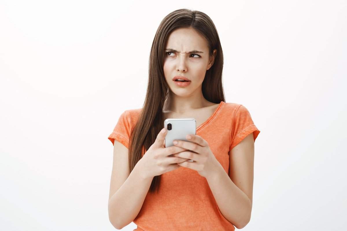 Click on image of young woman on her iphone, to connect to the blogpost How to stop spam email on iphone
