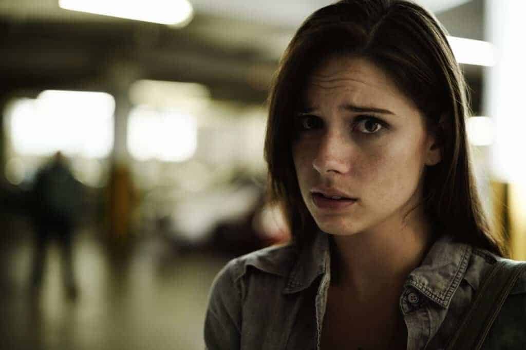 A terrified young woman in an underground parking garage becoming a victime of a Nip Farm Scam