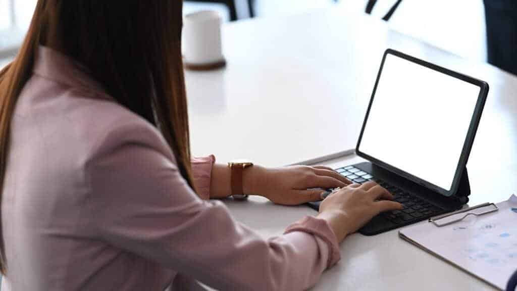 A woman tracking a missed Royal Mail delivery package online using  a laptop