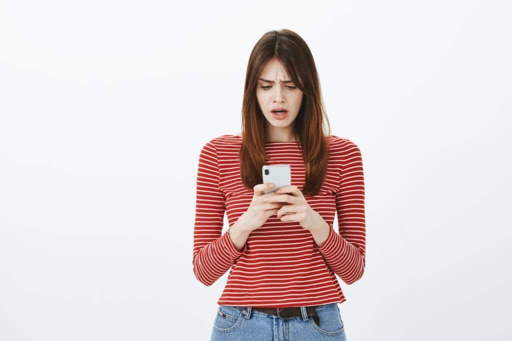 Girl looking shocked, seeing her facebook account hacked email and phone changed