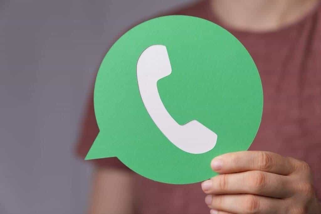 Lady holding a green photo of a white phone with a green background