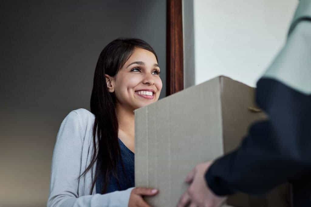 A young woman collecting her package from a depot